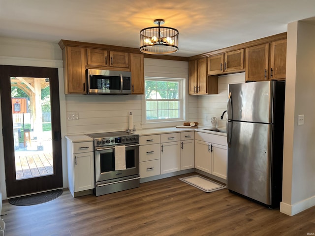 1503 W Ave, Goshen, IN 46526 - kitchen featuring stainless steel appliances, backsplash, light countertops, dark wood-style flooring, and a chandelier