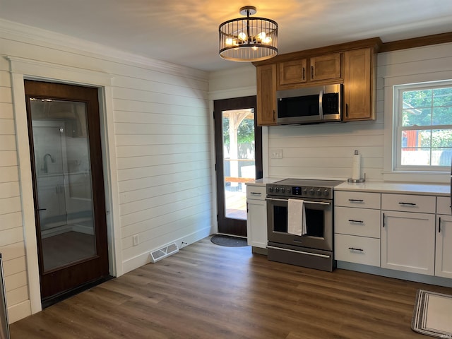 1503 W Ave, Goshen, IN 46526 - kitchen with stainless steel appliances, light countertops, healthy amount of natural light, and wooden walls