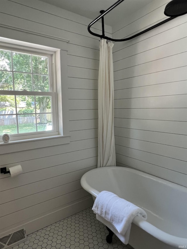 1503 W Ave, Goshen, IN 46526 - bathroom featuring wood walls, tile patterned floors, and shower / bath combination with curtain