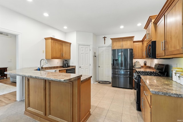 1208 Phaeton Way, Auburn, IN 46706 - kitchen with black appliances, a peninsula, light tile patterned flooring, brown cabinets, and recessed lighting