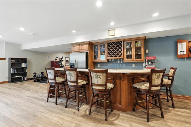 1208 Phaeton Way, Auburn, IN 46706 - indoor bar with stainless steel fridge, light wood-style flooring, and recessed lighting
