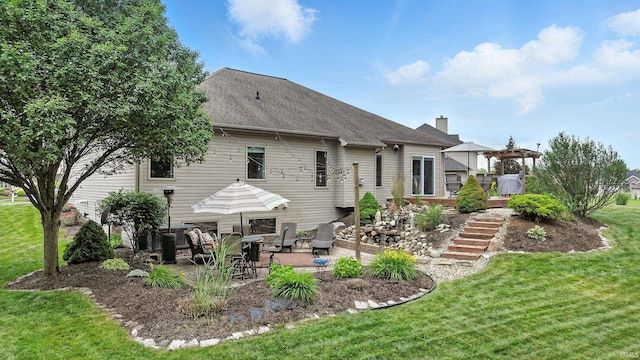 1208 Phaeton Way, Auburn, IN 46706 - rear view of property featuring a lawn, a patio area, a chimney, stairs, and a deck