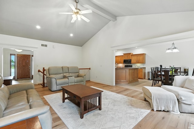 1208 Phaeton Way, Auburn, IN 46706 - living area featuring beamed ceiling, ceiling fan, light wood-style floors, high vaulted ceiling, and recessed lighting