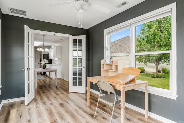 12909 Cocoplum Ct, Fort Wayne, IN 46814 - dining room with french doors, light wood finished floors, ceiling fan, and a chandelier