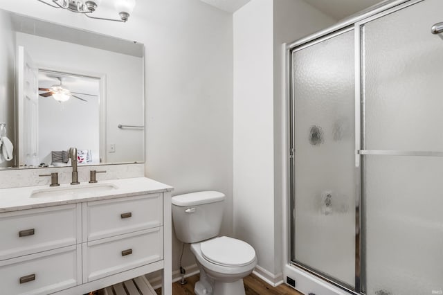 12909 Cocoplum Ct, Fort Wayne, IN 46814 - bathroom with a stall shower, vanity, a ceiling fan, and wood finished floors