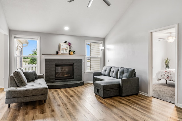 12909 Cocoplum Ct, Fort Wayne, IN 46814 - living area featuring a ceiling fan, wood finished floors, a brick fireplace, and high vaulted ceiling