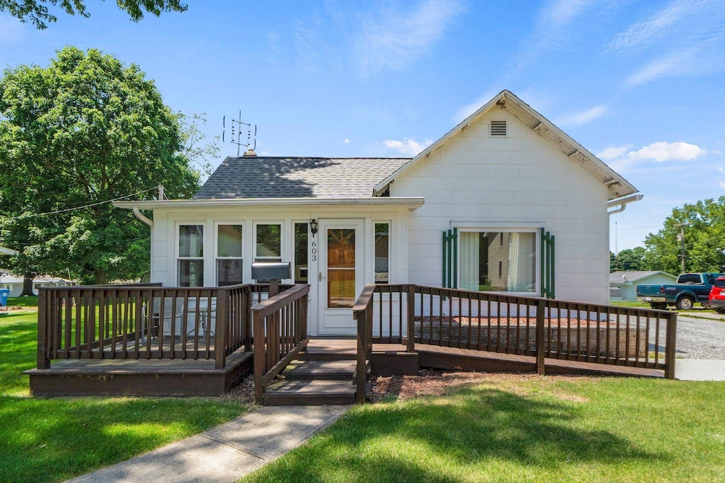 603 N Calhoun St, South Whitley, IN 46787 - view of front of home with roof with shingles, a front lawn, and a deck
