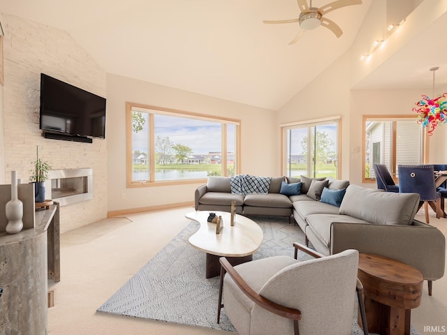 8018 Inverness Lakes Trl, Fort Wayne, IN 46804 - living area with carpet, a stone fireplace, a ceiling fan, plenty of natural light, and high vaulted ceiling