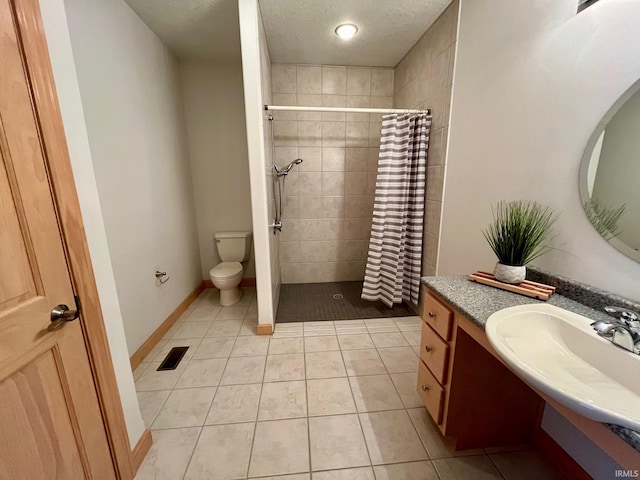 8018 Inverness Lakes Trl, Fort Wayne, IN 46804 - full bathroom featuring vanity, tiled shower, tile patterned floors, and a textured ceiling