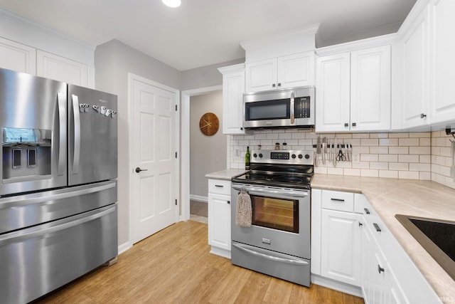 9628 Trading Post Rd, Leo, IN 46765 - kitchen with stainless steel appliances, tasteful backsplash, light countertops, and white cabinets