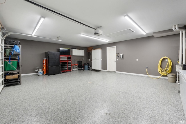9628 Trading Post Rd, Leo, IN 46765 - garage with freestanding refrigerator and baseboards