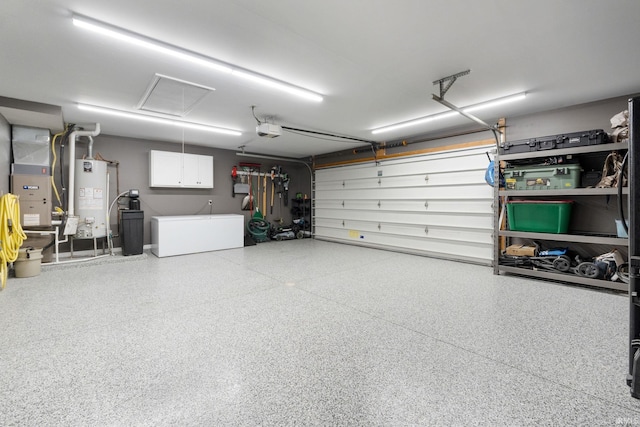 9628 Trading Post Rd, Leo, IN 46765 - garage with gas water heater, a garage door opener, heating unit, and fridge