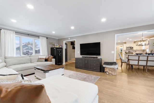 9628 Trading Post Rd, Leo, IN 46765 - living room featuring crown molding, a chandelier, recessed lighting, and light wood-style floors
