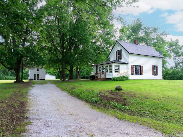 12632 N 325 E, North Manchester, IN 46962 - view of front of house with driveway, a chimney, a front lawn, and an outdoor structure