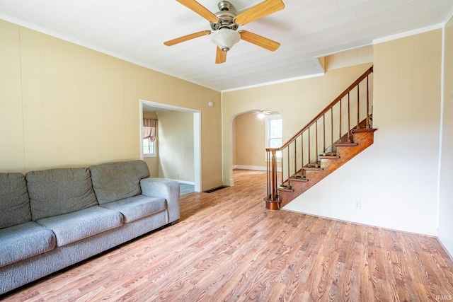 12632 N 325 E, North Manchester, IN 46962 - living room with arched walkways, stairs, wood finished floors, a ceiling fan, and plenty of natural light