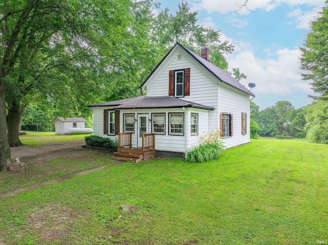 12632 N 325 E, North Manchester, IN 46962 - view of front of house with a chimney, a shingled roof, and a front yard