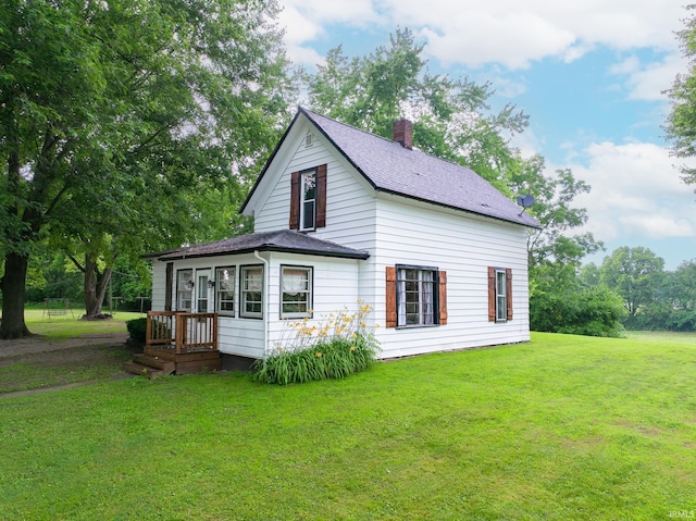12632 N 325 E, North Manchester, IN 46962 - view of side of home featuring a lawn, a chimney, and a shingled roof