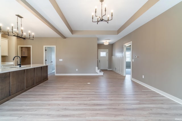 7751 Luna Way, Fort Wayne, IN 46835 - kitchen featuring a chandelier, light countertops, light wood finished floors, and pendant lighting