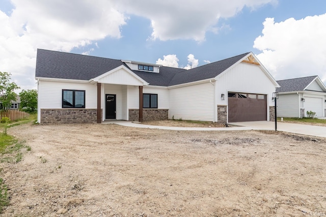 7751 Luna Way, Fort Wayne, IN 46835 - modern inspired farmhouse featuring an attached garage, stone siding, concrete driveway, and a shingled roof