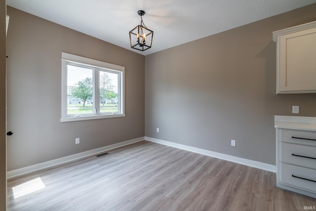 7751 Luna Way, Fort Wayne, IN 46835 - unfurnished dining area featuring a chandelier and light wood-style floors