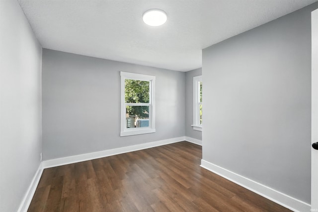 2020 Electric Ave, Fort Wayne, IN 46802 - spare room featuring dark wood-type flooring and baseboards