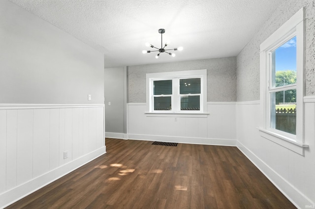 2020 Electric Ave, Fort Wayne, IN 46802 - empty room featuring wainscoting, a textured ceiling, a chandelier, and wood finished floors