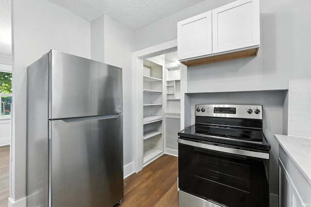 2020 Electric Ave, Fort Wayne, IN 46802 - kitchen with appliances with stainless steel finishes, dark wood-style flooring, white cabinetry, and a textured ceiling