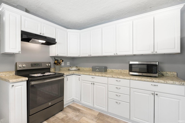 4831 Woodford Dr, Fort Wayne, IN 46835 - kitchen with stainless steel appliances, under cabinet range hood, white cabinets, light wood finished floors, and light countertops