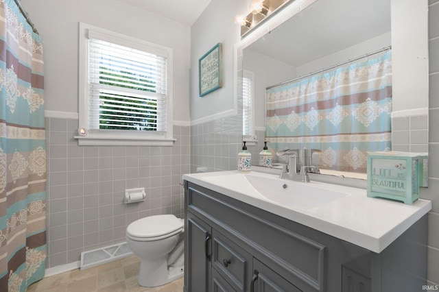 4831 Woodford Dr, Fort Wayne, IN 46835 - full bathroom with vanity, tile walls, and wainscoting