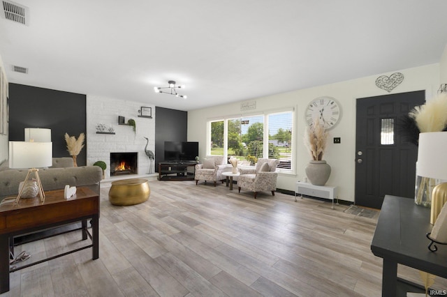 4831 Woodford Dr, Fort Wayne, IN 46835 - living room featuring a fireplace and light wood-style floors