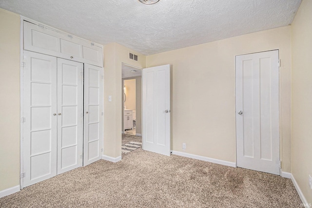 1641 N Adams St, South Bend, IN 46628 - unfurnished bedroom featuring carpet floors, a textured ceiling, and a closet
