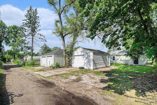 1641 N Adams St, South Bend, IN 46628 - view of yard featuring an outdoor structure and a garage