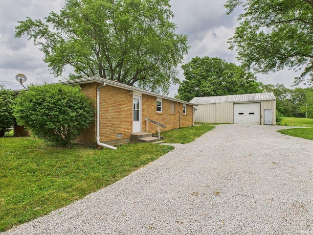 203 E Plum St, Frankton, IN 46044 - view of side of property with brick siding, driveway, an outbuilding, a garage, and a lawn