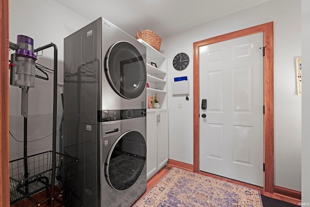 16619 Amethyst Pkwy, Fort Wayne, IN 46845 - washroom featuring stacked washer / dryer, wood finished floors, and cabinet space