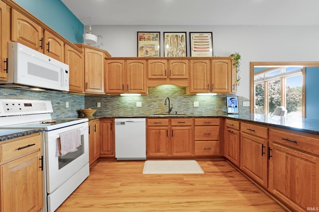 16619 Amethyst Pkwy, Fort Wayne, IN 46845 - kitchen featuring white appliances, decorative backsplash, dark stone counters, and light wood-style floors
