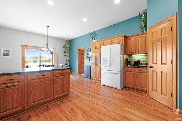 16619 Amethyst Pkwy, Fort Wayne, IN 46845 - kitchen with white refrigerator with ice dispenser, dark countertops, light wood finished floors, a chandelier, and recessed lighting