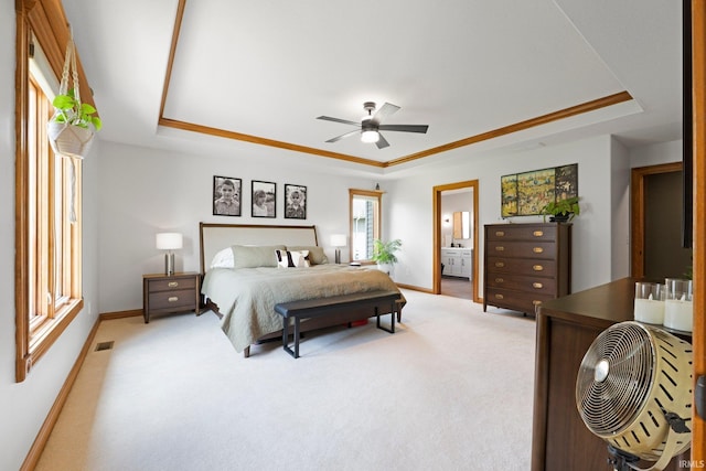 16619 Amethyst Pkwy, Fort Wayne, IN 46845 - bedroom featuring a tray ceiling, light colored carpet, connected bathroom, and ceiling fan