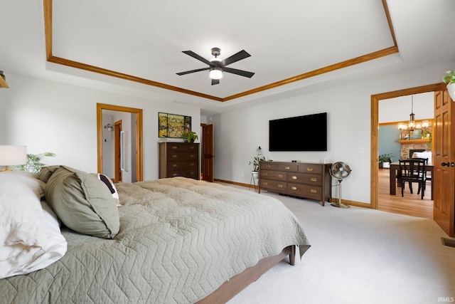 16619 Amethyst Pkwy, Fort Wayne, IN 46845 - carpeted bedroom with a tray ceiling, a chandelier, and a ceiling fan