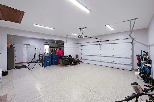 16619 Amethyst Pkwy, Fort Wayne, IN 46845 - garage with freestanding refrigerator and a garage door opener