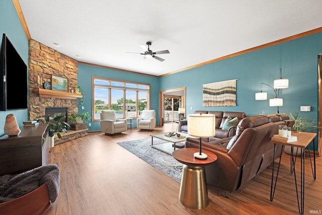 16619 Amethyst Pkwy, Fort Wayne, IN 46845 - living room featuring ceiling fan, ornamental molding, wood finished floors, and a stone fireplace
