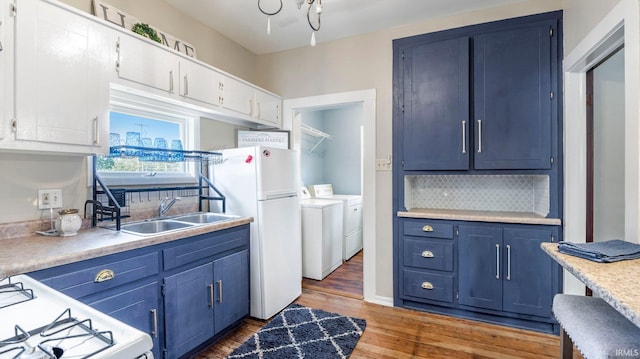 1607 Franklin Ave, Fort Wayne, IN 46808 - kitchen with washing machine and clothes dryer, white appliances, and blue cabinetry