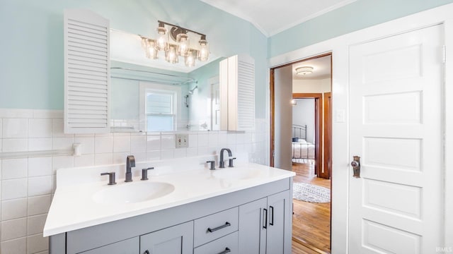 1607 Franklin Ave, Fort Wayne, IN 46808 - ensuite bathroom with ornamental molding, double vanity, wood finished floors, and tile walls