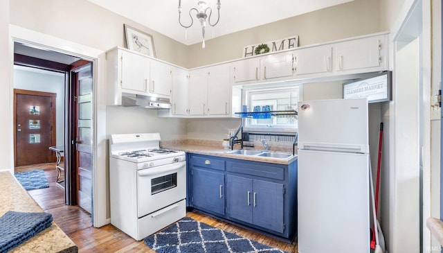 1607 Franklin Ave, Fort Wayne, IN 46808 - kitchen featuring white appliances, under cabinet range hood, light countertops, light wood finished floors, and blue cabinetry