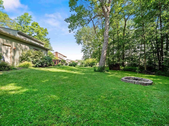 8220 Sakaden Pkwy, Fort Wayne, IN 46825 - view of green lawn featuring a fire pit