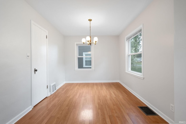 1738 Sunnymede Ave, South Bend, IN 46615 - empty room featuring light wood-style flooring and a chandelier