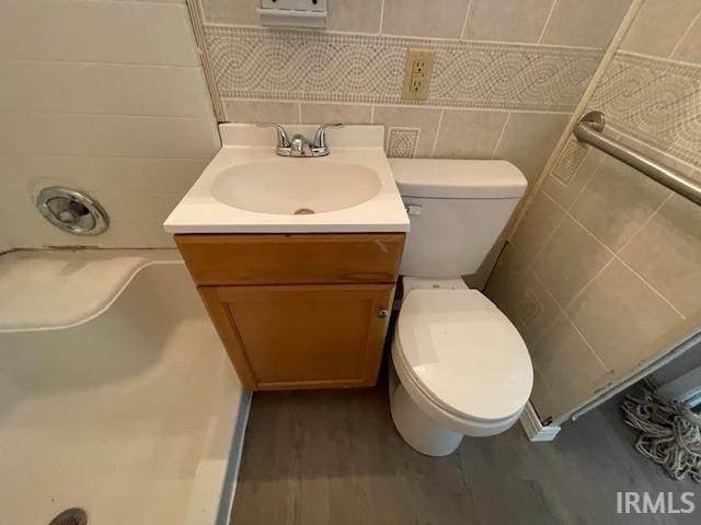 106 N Wellington St, South Bend, IN 46619 - full bathroom featuring vanity, a shower, tile walls, wood finished floors, and a bath