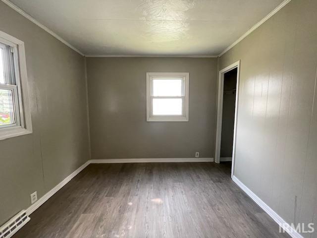 106 N Wellington St, South Bend, IN 46619 - empty room featuring wood finished floors and ornamental molding
