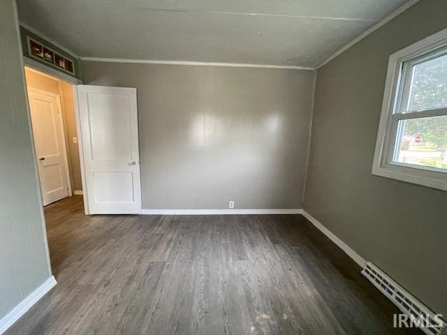 106 N Wellington St, South Bend, IN 46619 - spare room with crown molding, wood finished floors, and baseboard heating