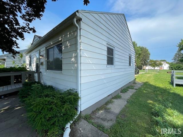 106 N Wellington St, South Bend, IN 46619 - view of side of home featuring a yard and a wooden deck