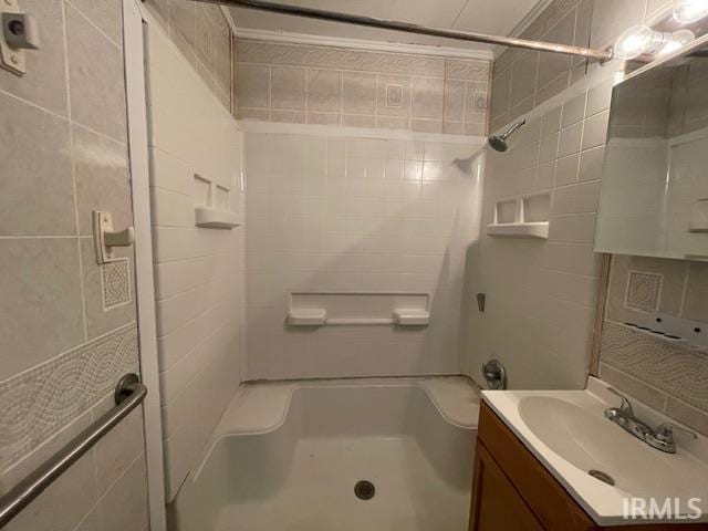 106 N Wellington St, South Bend, IN 46619 - bathroom featuring a shower, vanity, and tile walls